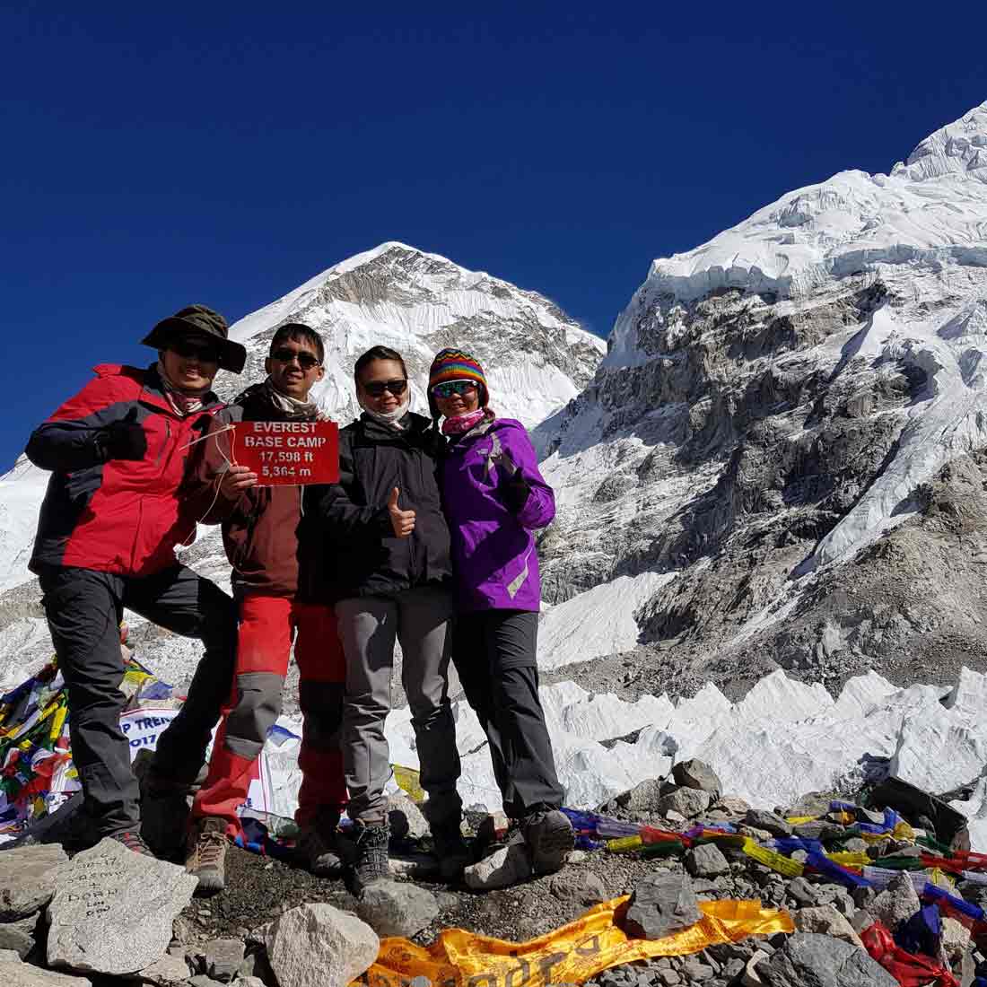 Andrew (holding sign) on a 12-day trek to Everest Base Camp with his wife and friends